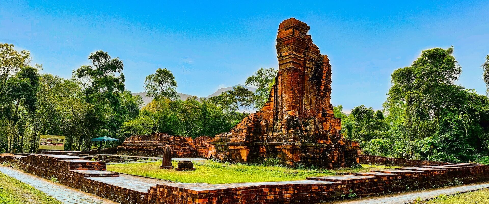 Lush My Son sanctuary at sunset on a My Son Travel banner by Legend Travel Group.